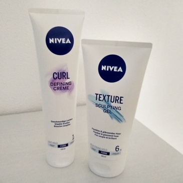 Picture of a tube of Nivea Curl Defining Creme and a tube of Nivea Texture Sculpting Gel standing on a white background