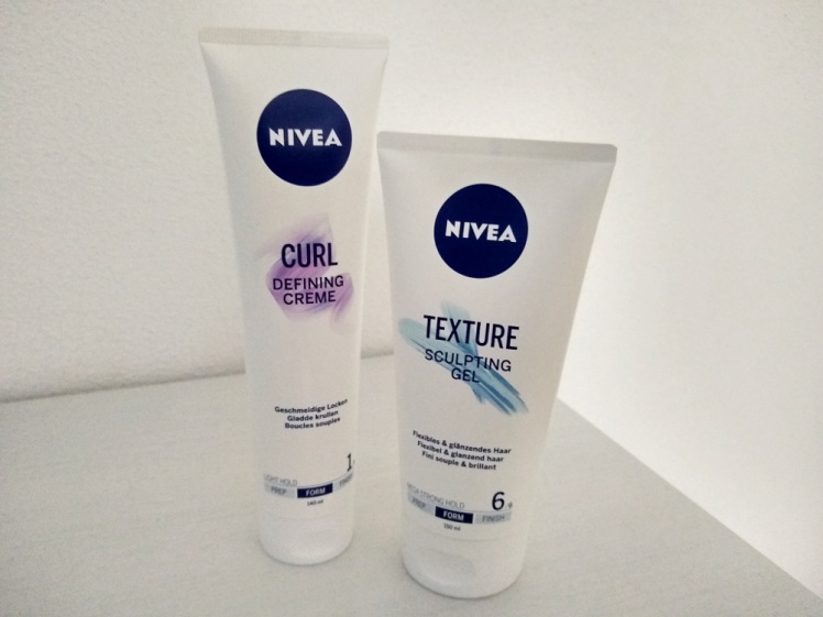 Picture of a tube of Nivea Curl Defining Creme and a tube of Nivea Texture Sculpting Gel standing on a white background